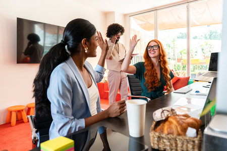 Multiethnic small group of businesspeople meeting in a coworking corporate company office - Young coworkers colleagues working together in a creative startup tech company, concepts about business and daily office lifestyleの写真素材