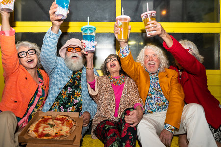 Group of happy senior friends with fancy clothing having party in the night on city streets - Cheerful elderly people wearing fashionable clothes celebrating and having fun outdoorsの写真素材