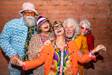 Group of happy senior friends with fancy clothing having party in the night on city streets -...