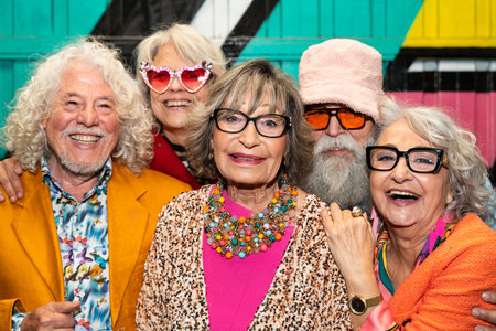 Group of happy senior friends with fancy clothing having party in the night on city streets - Cheerful elderly people wearing fashionable clothes celebrating and having fun outdoorsの写真素材