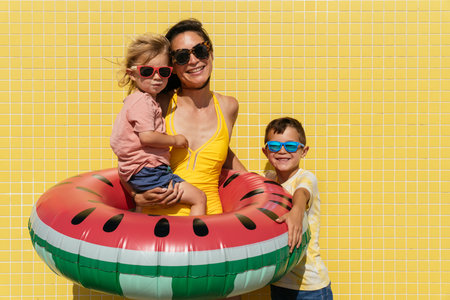Happy beautiful asian family having fun at the beach during summertime vacation - mother and mixed...