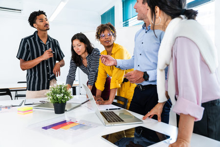 Diverse team of professionals gathered around a table, actively discussing and collaborating on a...