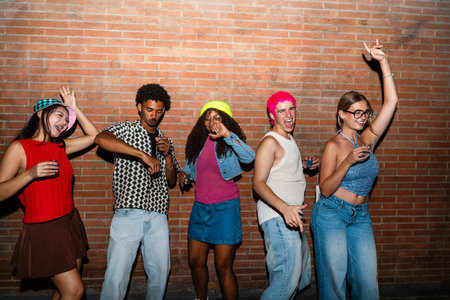 Multiethnic group of young friends having fun on the streets in the night - Stylish cool multiracial...