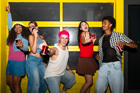 Multiethnic group of young friends having fun on the streets in the night - Stylish cool multiracial...