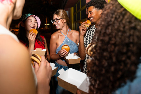 Multiethnic group of young friends having fun on the streets in the night - Stylish cool multiracial...