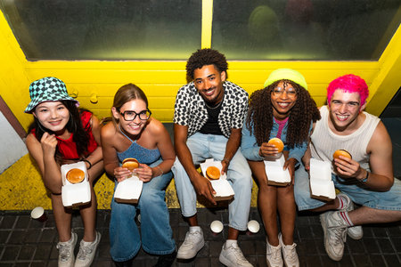 Multiethnic group of young friends having fun on the streets in the night - Stylish cool multiracial...