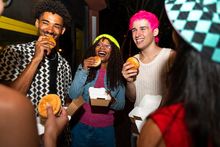 Multiethnic group of young friends having fun on the streets in the night - Stylish cool multiracial...
