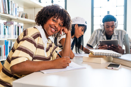 Multiethnic group of young students meeting at the library - young diverse students collaborating,...