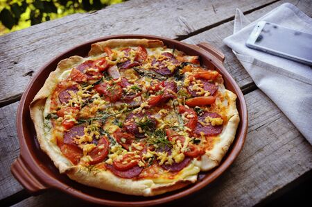 Delicious italian pizzas served on wooden tableの写真素材