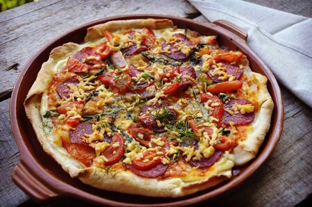 Delicious italian pizzas served on wooden tableの写真素材