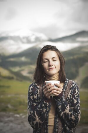 Girl in the mountains drinking teaの写真素材