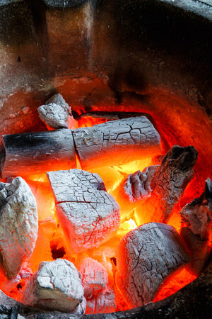 Glowing red hot fire with burning charcoalの写真素材