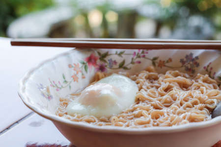 Instant noodles in bowl with eggの写真素材