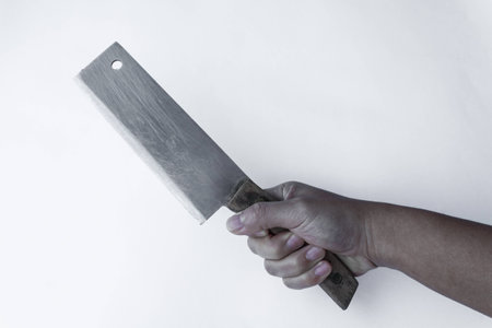 Chopping knife in hand on grey background