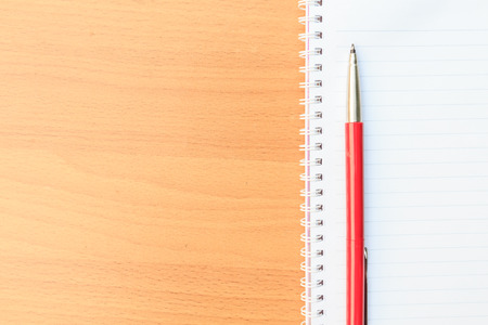 Notebook and pen on brown tableの写真素材