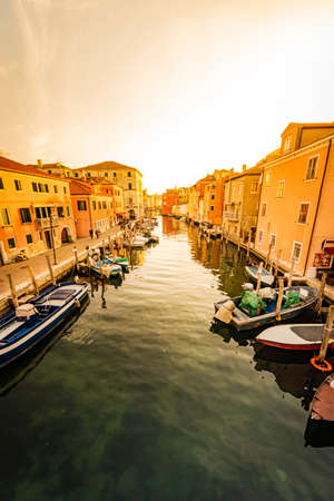 Romantic cityscape of Ghioggia - near Venice - with canals, buidings, bridges and canals in sunset sunlight. Bridge of Vicoの写真素材