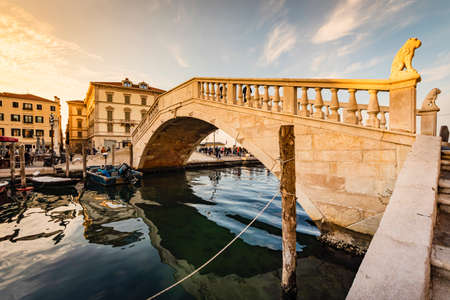 Romantic cityscape of Ghioggia - near Venice - with canals, buidings, bridges and canals in sunset sunlight. Bridge of Vicoの写真素材