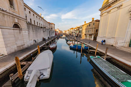 Romantic cityscape of Ghioggia - near Venice - with canals, buidings, bridges and canals in sunset sunlight. Philippine Bridgeの写真素材
