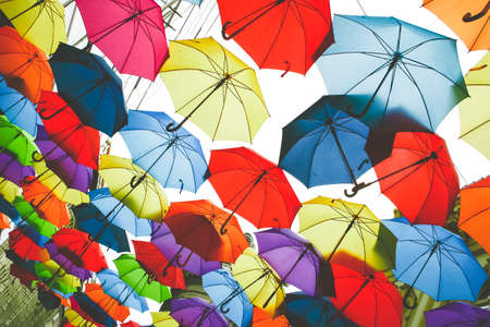 Many multicolored open umbrellas, view from below, concept of protection, cheer, colorful backgroundの写真素材