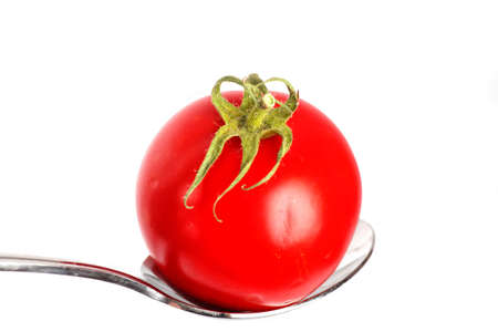 Fresh garden tomato on a spoon.の写真素材