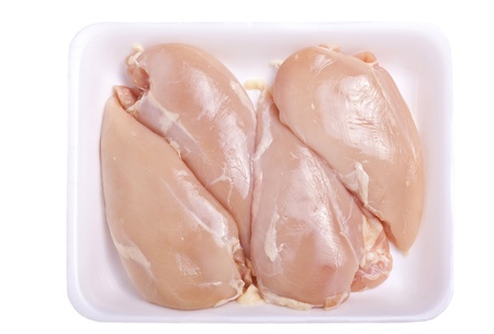 Raw boneless and skinless chicken breast in a styrofoam tray or container の写真素材