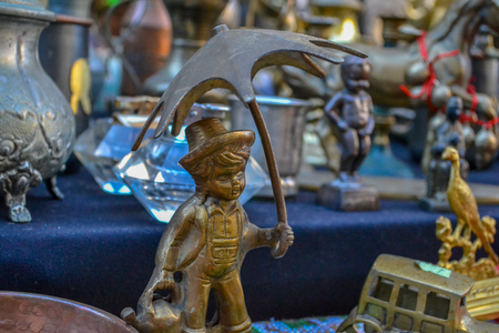 Metal figurine of a little boy with umbrellaの写真素材