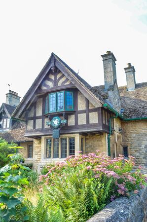 Tudor style House with chimneys, Leicestershire England with ornate windows and tiled roof. の写真素材