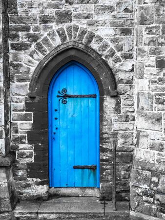 A blue church door Penzance Cornwall with grey stone work and saturated blue colour.の写真素材