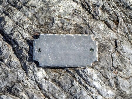 Metal empty label on stone.