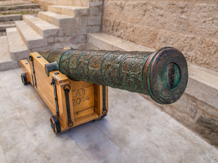 Old medieval artillery cannon with wooden stand in Komiza city on the Island Vis. Croatia.のeditorial素材