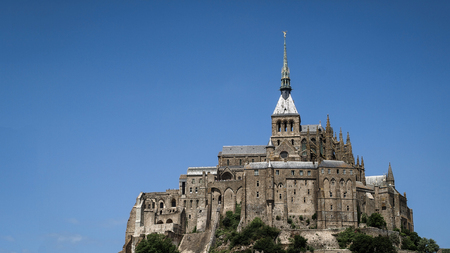 Panoramic view of Mont-Saint-Michel monastery with blue sky in the background.France, Europe.のeditorial素材