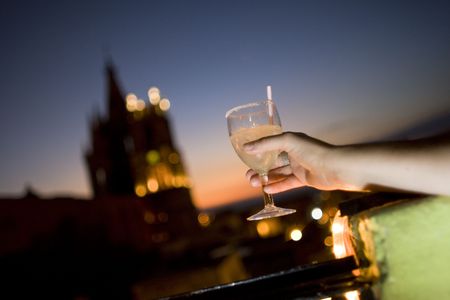 A womans hand holding a margarita on a balcony in Mexico overlooking San Miguel de Allendeの写真素材