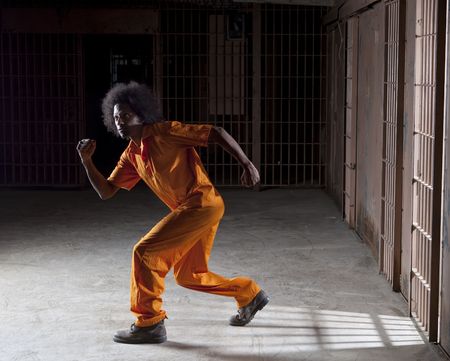 A black man with an afro making various faces and gestures inside a federal prisonの写真素材
