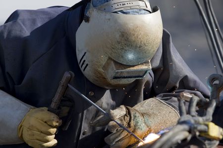 A welder welding a pipeの写真素材