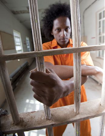 A black man with an afro making various faces and gestures inside a federal prisonの写真素材