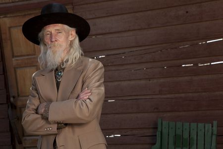 An elderly western genetleman in a suit and cowboy hatの写真素材