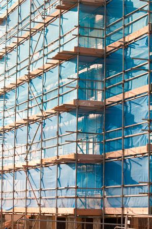 Access scaffold UK style with blue safety netting.の写真素材