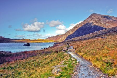 Cwm Idwal comprises volcanic and sedimentary rock which was laid down in a shallow Ordovician sea 450 million years ago, and later pushed up and deformed into the distinctive u-shaped fold known today as the Idwal Syncline.の写真素材