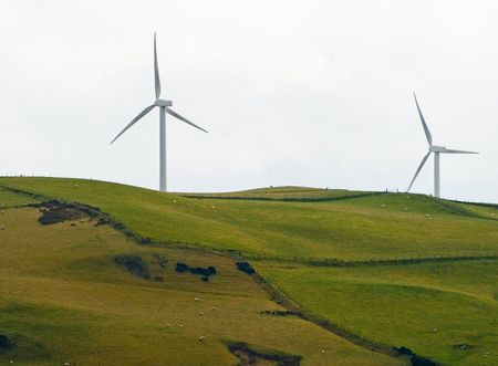 Wind Turbines harvesting natural energy on a hillside in Wales, UK.の写真素材