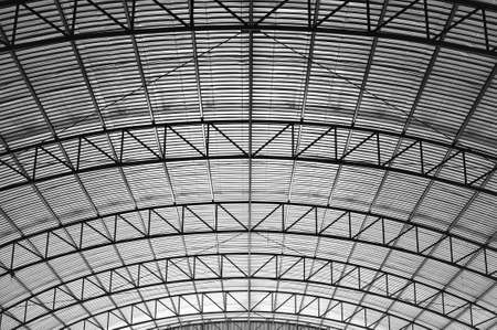 Curved truss high roof suppot within a warehouseの写真素材