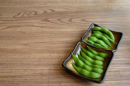 Boiled japanese green soy bean or stem bean served in a restaurant as appetizerの写真素材