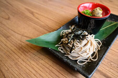 Japanese style noodle served with sauce, onion, grouse egg, wasabi and gingerの写真素材