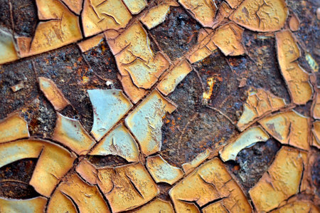 Old and cracked coating color on rusty iron surface