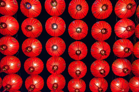 Chinese red lanterns hanging in street at night for decoration during the Chinese New Year festival at Chinatown, Ratchaburi, Thailand Chinese Red lanterns illuminated at nightの写真素材