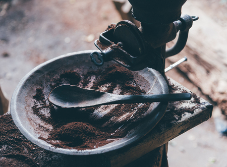 Roasted coffee bean with brown metal vintage antique grinder coffee with handle. traditional old mill for kitchen beverage maker.の写真素材