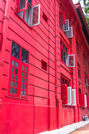 Red Colonial building with red door and red windowsの写真素材