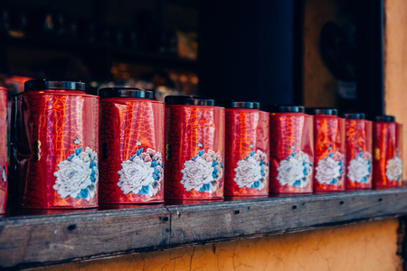 Red tea boxes in a row on shelf.Group of premium gold tea boxes in vintage style.の写真素材