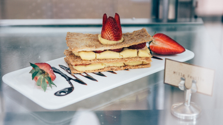 Mille Feuille dessert with strawberries dessert sweet cake.Puff homemade cake with cream and berries. vintage tone background.French gourmet strawberry mille feuille with whipped sour cream.の写真素材