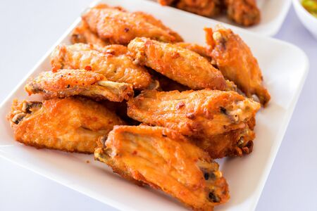 Thai style homemade fried chicken wings on white plate.A plate of fresh, hot, crispy fried chicken.の写真素材