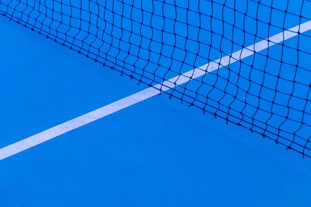 Blue tennis court surface, sport background.Detail of a tennis courtTennis court with net background.の写真素材